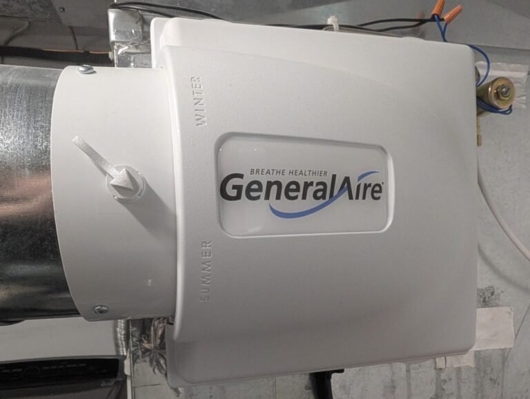 White GeneralAire whole-home humidifier fitted on supply ductwork with the front label facing out